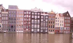 damrak canal amsterdam - terminal for grey line cruises departure arrivals buildings leaning canal picturesque sex museum