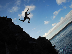 risk risk taking man jumping off cliff