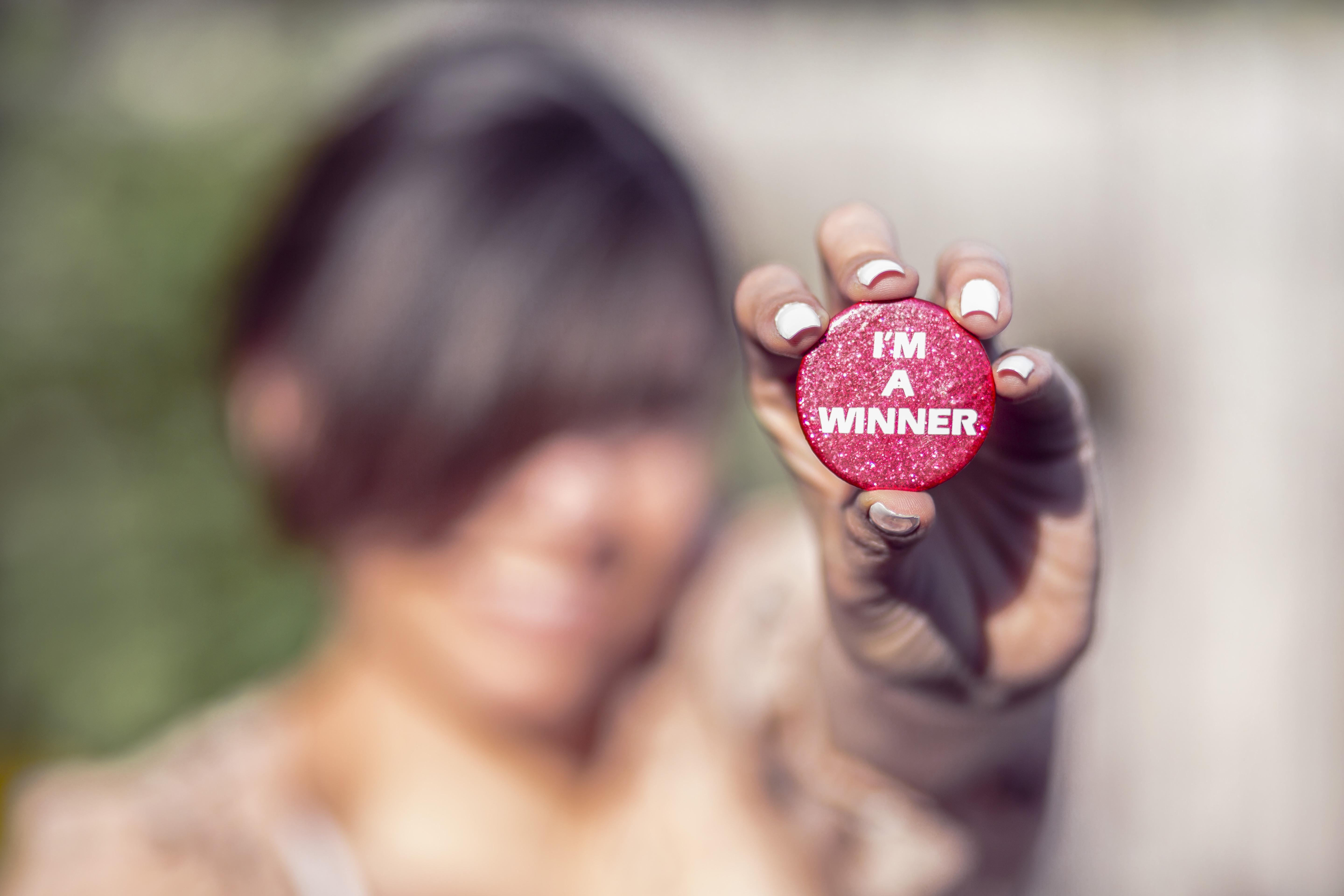 woman holding i'm a winner button