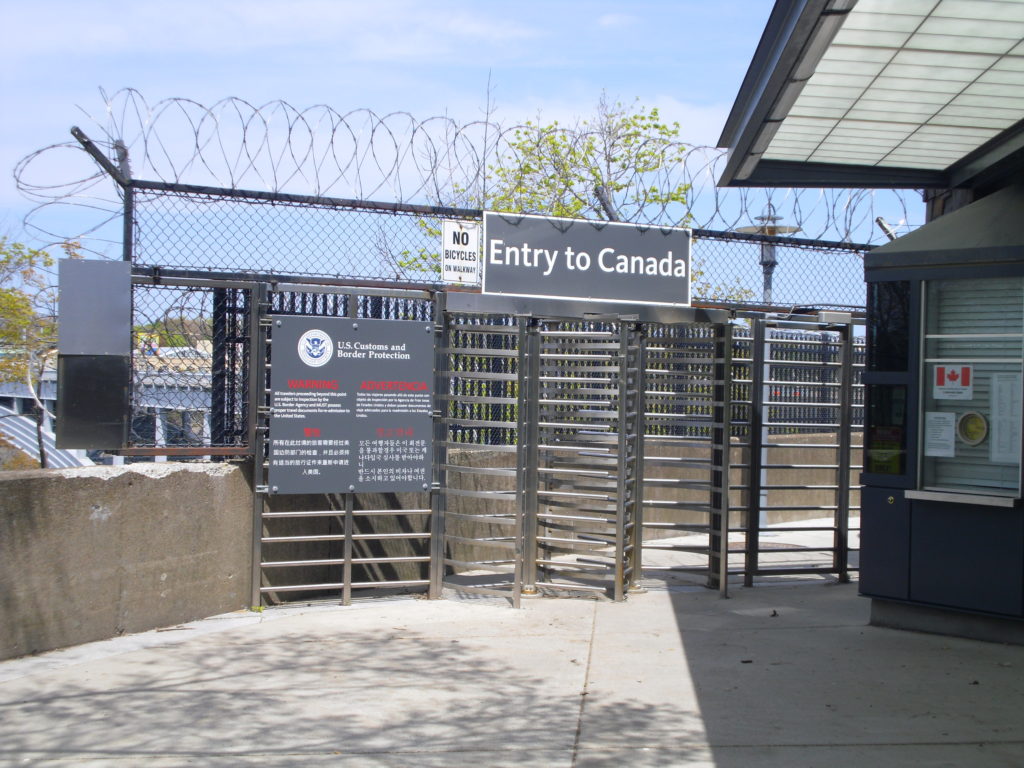 pass through the gate to walk on the international footbridge at niagara falls that leads to the Canadian side just like top travel blog half the clothes' author Jema Patterson did