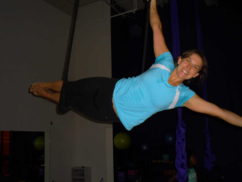 Top travel blog Half the Clothes' author Jema Patterson participates in a trapeze class in Kansas City at