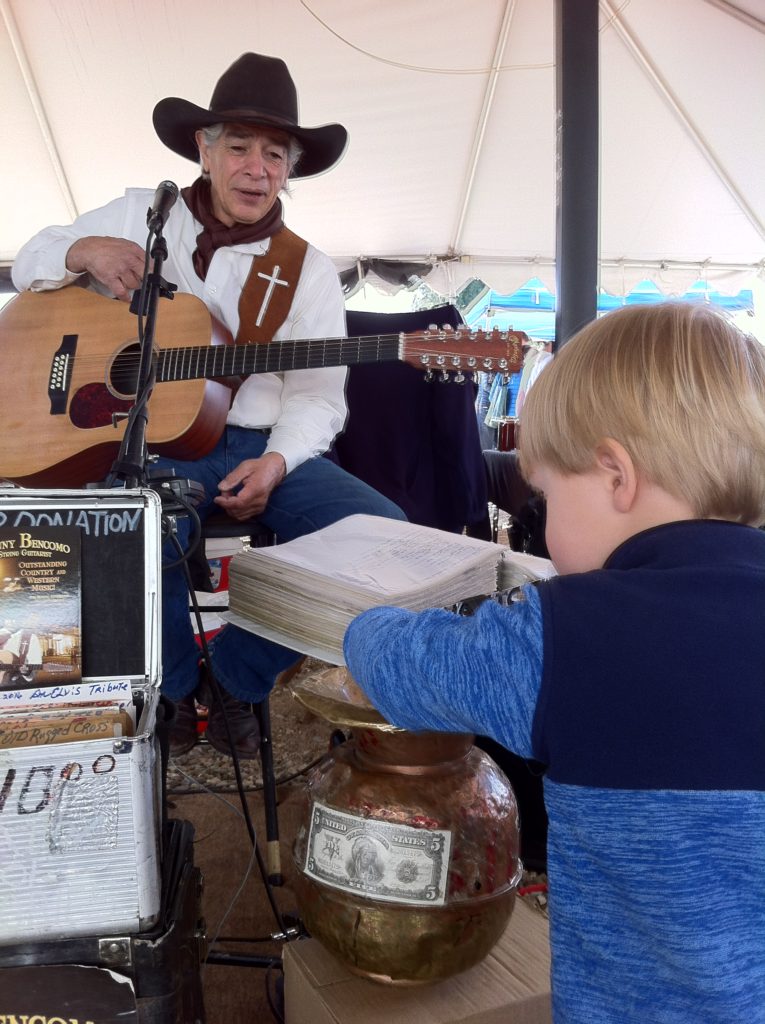 Top slow travel blog Half the Clothes author loves farmer's markets. With cute toddler = bonus #1. With music = bonus #2