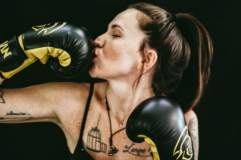 if you want to know how to save money to travel, you're going to need to get our your gloves like this woman and grow your money muscles