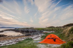 This is a great interpretation of a great free sleeping hotel: an orange camping tent on the coast! Exchange a room at a hotel for waking up to this fantastic view of the water in the morning.