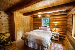 Sleep overnight in this relaxing bedroom with a queen size bed and white sheets. Enjoy your safe, free lodging at a place like this.